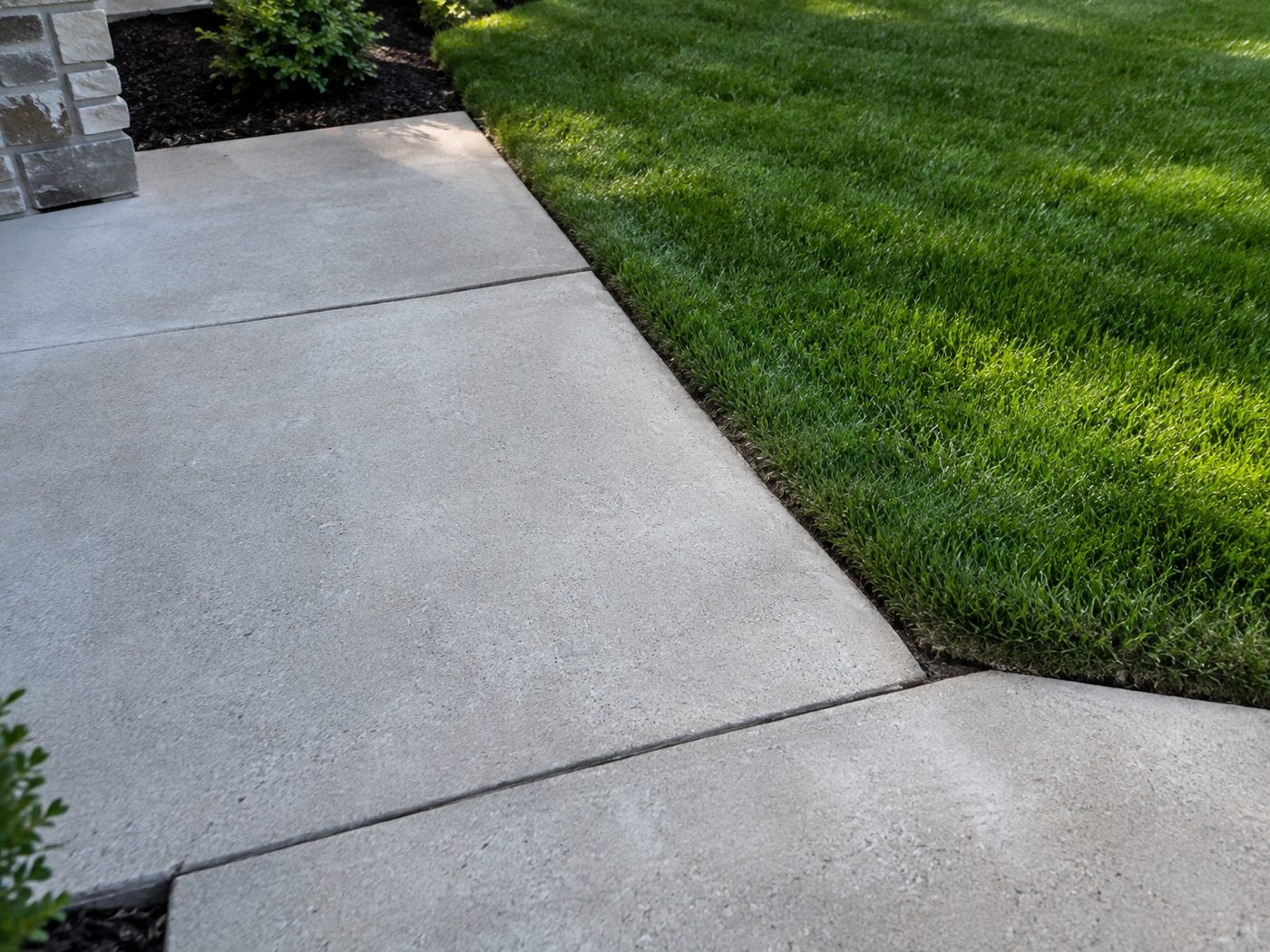 Clean lawn edging along a concrete walkway